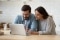 Couple sitting in front of laptop